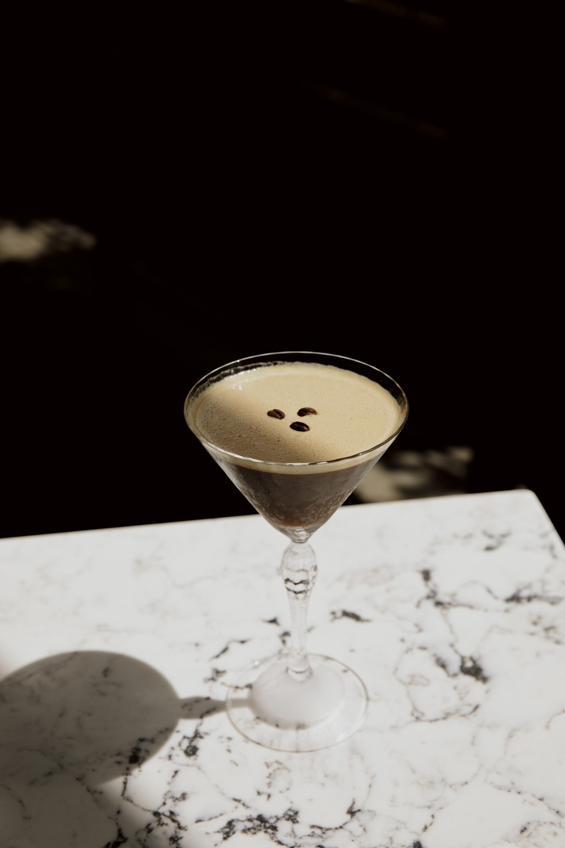 An espresso martini on white marble